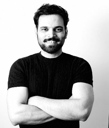 Tejas Machado, arms crossed, smiling